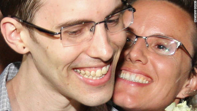 American hiker Shane Bauer, left, is embraced by fiancee Sarah Shourd after his release from Iran on Wednesday.