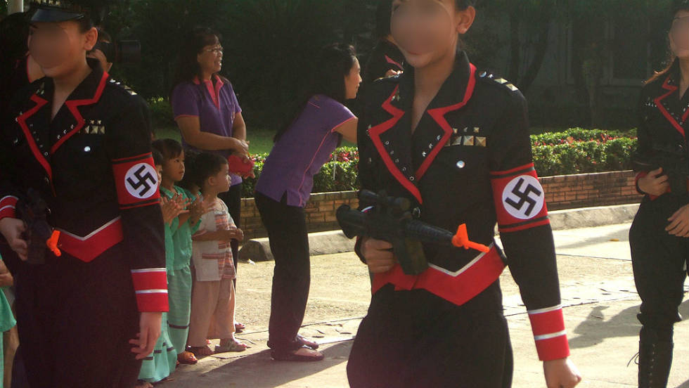 Students from the Sacred Heart School in Chiang Mai, Thailand took part in a parade wearing Nazi uniforms. Faces have been blurred to protect their identity. 