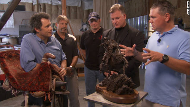 Former special operations forces tell sculptor Douwe Blumberg, left, about their mission in his Kentucky studio.