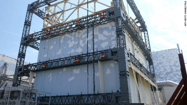 Fukushima Daiichi nuclear power plant Unit 1 reactor building is covered by a steel frame as a safety measure.  