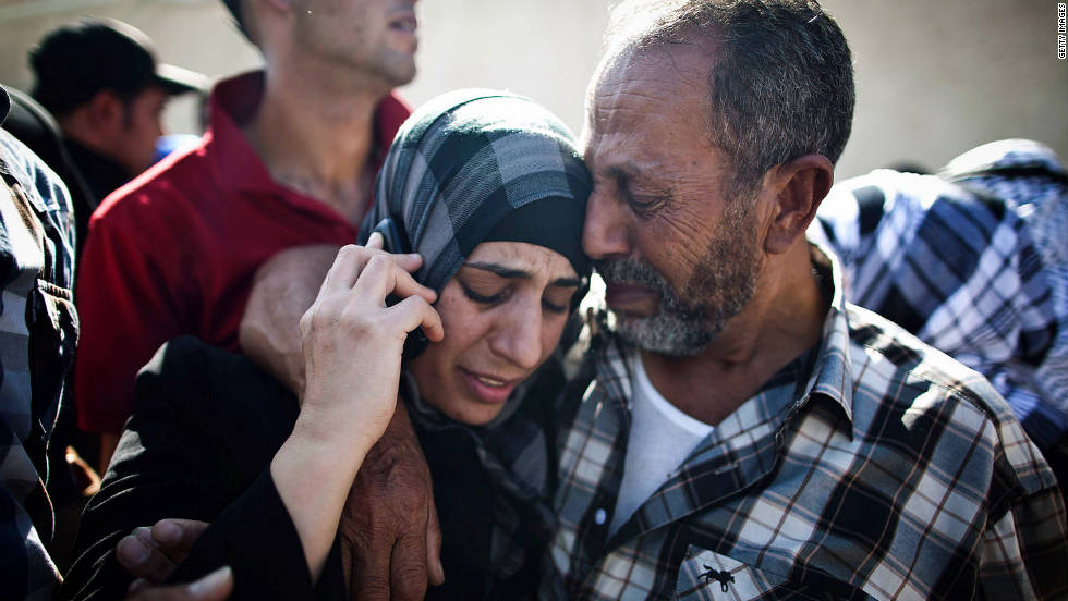 A Palestinian prisoner hugs relatives as she speaks on a mobile phone in Ramallah, West Bank, following her release on Tuesday.