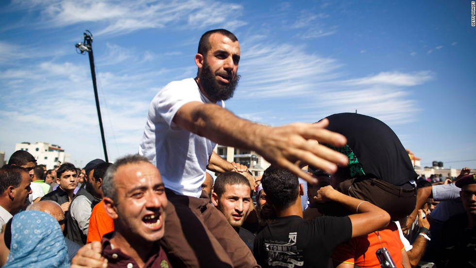 A Palestinian prisoner celebrates with relatives after being freed on Tuesday.