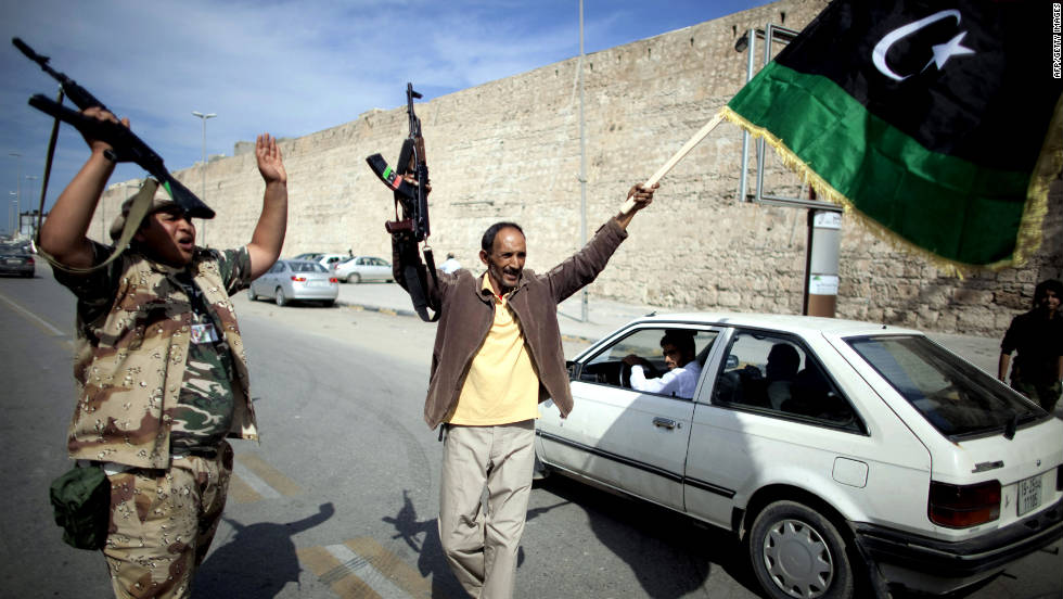 Libyan National Transitional Council fighters celebrate in the streets of Tripoli after news of Moammar Gadhafi&#39;s capture in Sirte on Thursday, October 20.