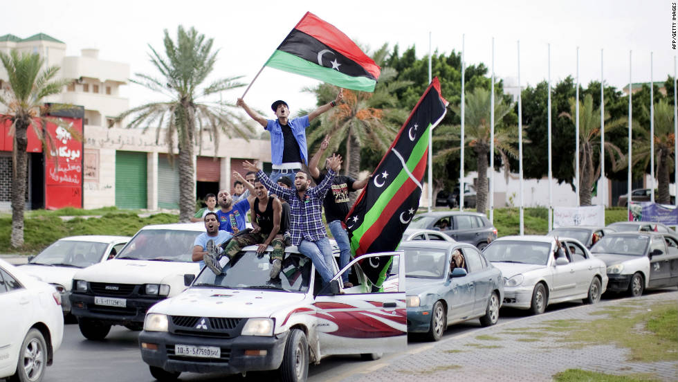 Libyans waving NTC flags celebrate in the streets of Tripoli on Thursday after news of Moammar Gadhafi&#39;s capture.