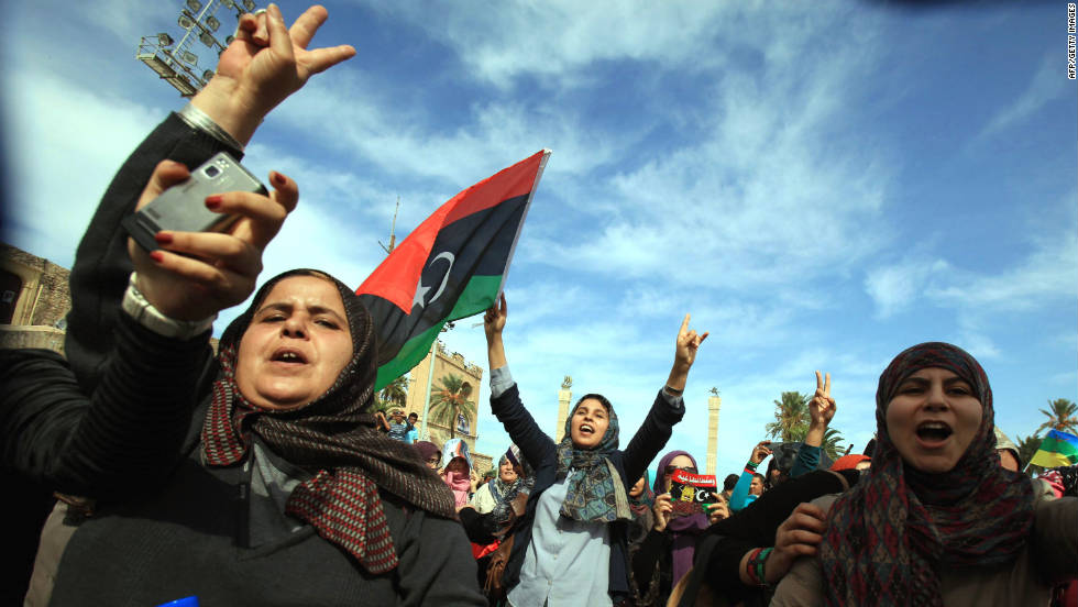 Libyans wave their new national flag as they celebrate in Tripoli. Interim Prime Minister Mahmoud Jibril told reporters Thursday that Gadhafi had been killed.