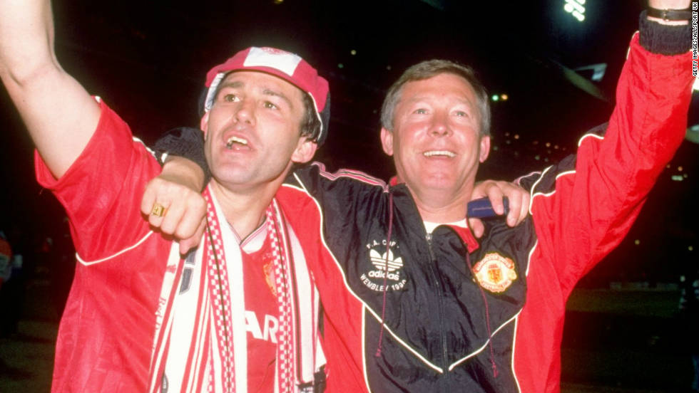Ferguson survived a difficult first four years at Manchester United before winning a title -- the 1990 FA Cup. Here he celebrates with Bryan Robson, who became the first United captain to lift the trophy three times after beating Crystal Palace 1-0 in the final replay. 