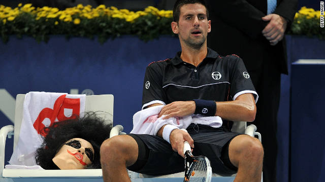 Novak Djokovic sits next to his Halloween mask during his match against Xavier Malisse at St Jakobshalle.