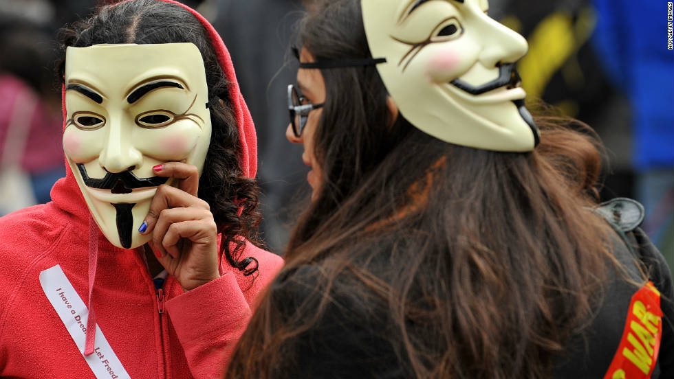 Protesters wearing Guy Fawkes masks gather outside St. Paul&#39;s Cathedral in London on October 16.