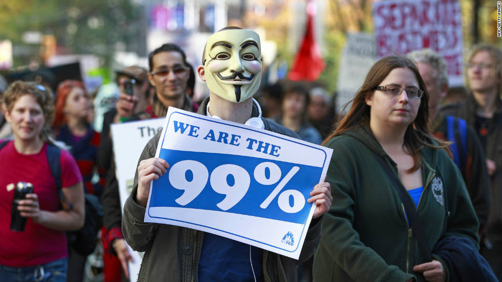 Another masked protester marches during Occupy Vancouver on October 15.