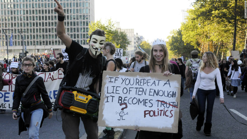 Another masked protester joins 6,000 people marching in Brussels, Belgium on October 15.