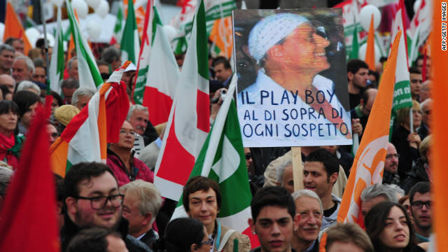 Demonstrators protest Berlusconi&#39;s government in 2011, holding a sign that reads &quot;The playboy above suspicion.&quot;
