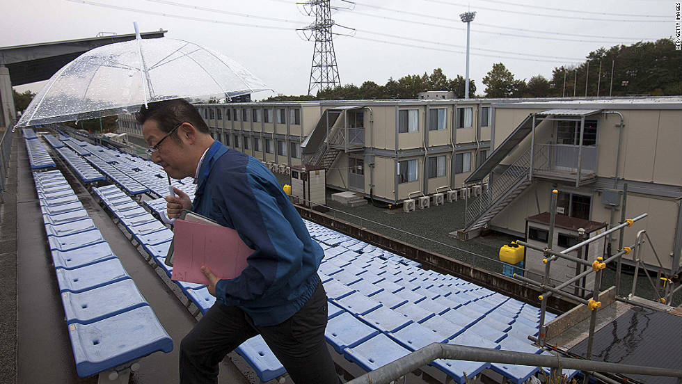 A employee of the Tokyo Electric Power Company walks up stairs near temporary housing built for workers who live at J-Village,  at the former soccer training complex.