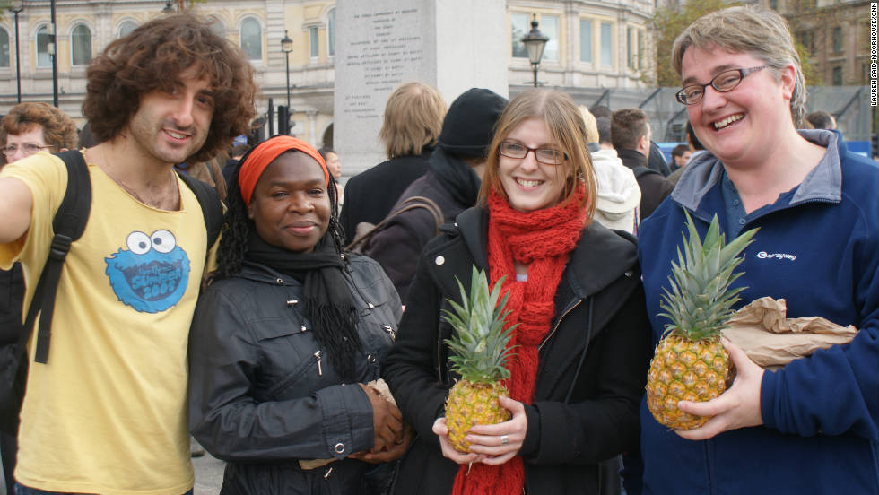 Volunteers from a Jewish charity show off waste pineapples which are being given to the public. Shelley Shocolinksky-Dwyer (far right) says: &quot;We wanted to help raise awareness and spread the message about food waste in the United Kingdom.&quot;