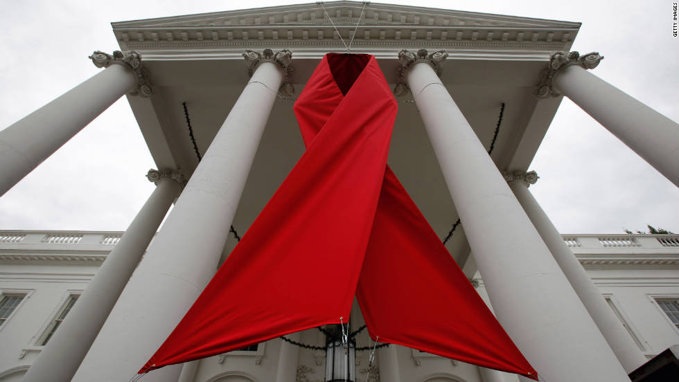 A red ribbon is hung between columns on the north side of the White House to commemorate World AIDS Day on November 30, 2010, in Washington. 