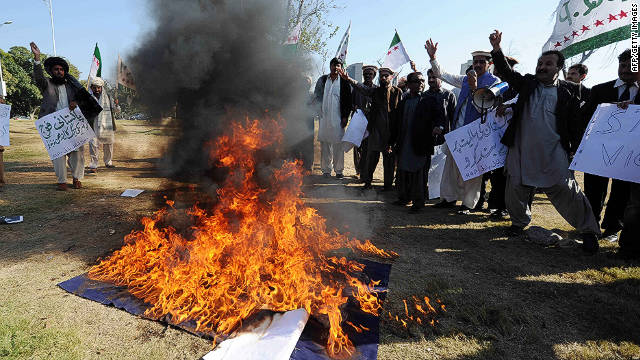 Pakistani tribesmen burn a NATO flag Tuesday during a demonstration in Islamabad to protest a NATO strike on Pakistani troops.