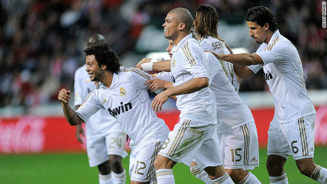 Marcelo (left) celebrates win his Real Madrid team mates after scoring the third goal in their La Liga win over Sporting Gijon 