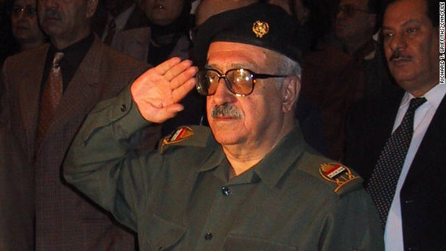 Tariq Aziz salutes as the Iraqi national anthem is played during a 2001 event.