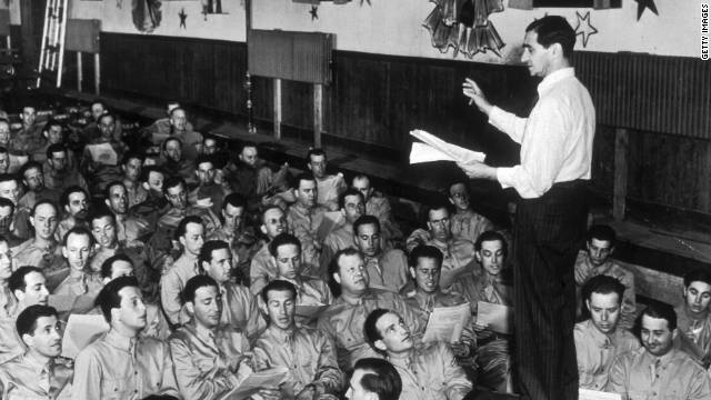 Composer Irving Berlin leads a group of servicemen at Camp Upton in Long Island, New York, in 1942. Berlin wrote &quot;God Bless America.&quot;
