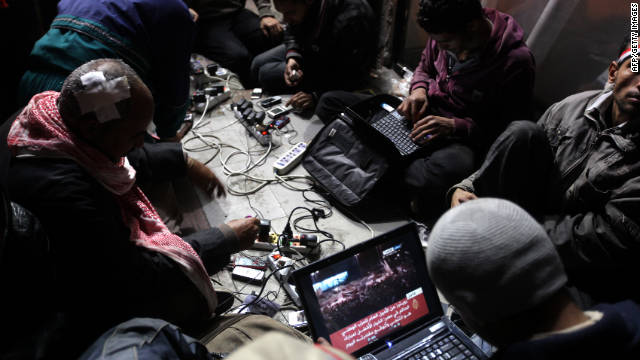 Egyptian anti-government bloggers work on their laptops from Tahrir Square during last year&#39;s uprising to oust Hosni Mubarak