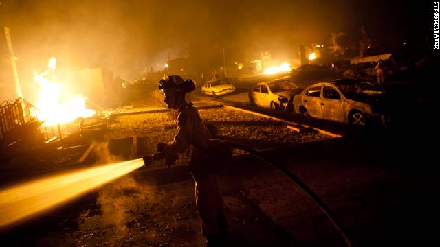 A firefighter works on a gas pipeline blaze September 9, 2010, in San Bruno, California.