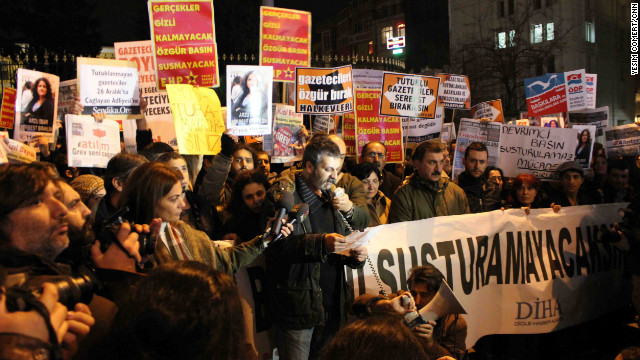 Journalists and human rights activists gather in Istanbul on Tuesday to protest the detention of dozens of journalists.