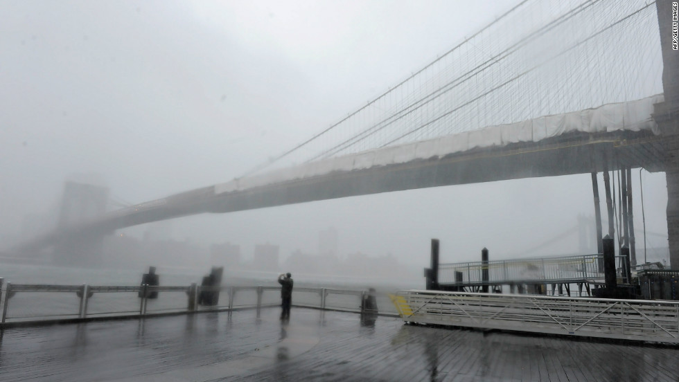 Brooklyn Bridge stands shrouded in heavy rain and dark clouds as Hurricane Irene reaches the New York City area on August 28, 2011. According to Jan Corfee-Morlot, senior climate change analyst for the OECD, many developed coastal cities around the world face a &quot;severe risk&quot; of floods in the coming years.