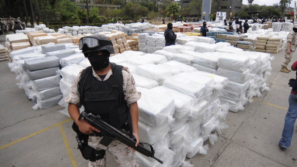 Mexican Federal Police stand guard over 105 tons of marijuana seized in Tijuana, Mexico, in October 2010. Smuggling remains a booming business. For example, south of the border it costs $2,000 to produce a kilo of cocaine from leaf to lab, according to the DEA. In America, a kilo&#39;s street value is significantly higher.