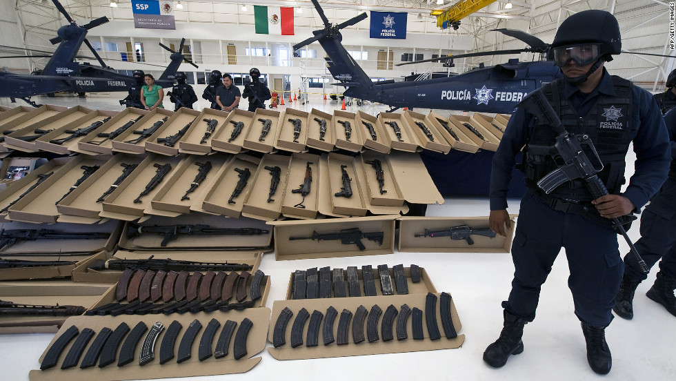 The cartels arm themselves heavily. Here, Mexican Federal Police display a large cache of high-powered weapons, grenades, ammunition and 2 kilos of cocaine, all seized from the Zetas cartel in October 2010.