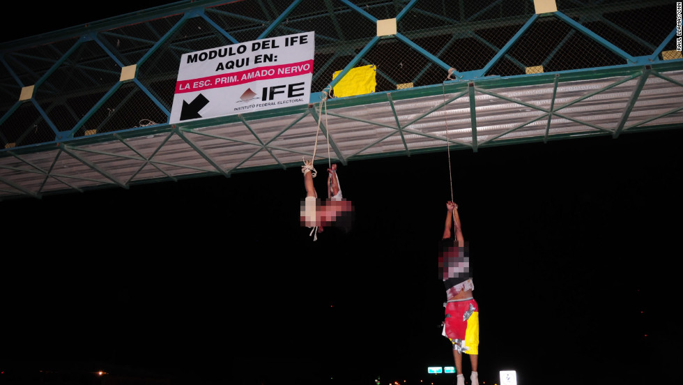 Two bodies hang from a bridge in Mexico in September 2011. Some cartels have developed reputations for sickening brutality -- seeming to kill for pleasure, just because they can.