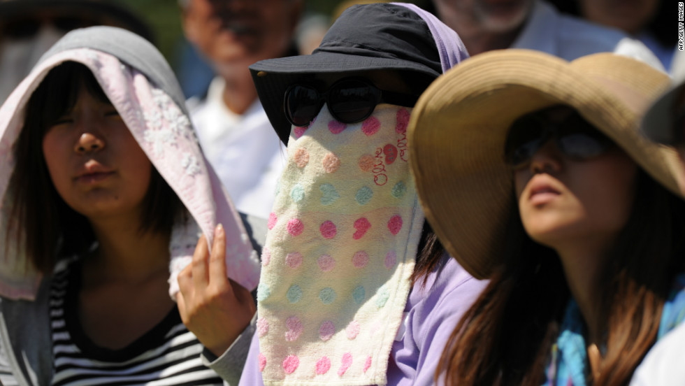 Spectators wear towels to beat the heat as Tatsuma Ito of Japan played Nicolas Mahut of France on the fourth day of the 2012 tournament in Melbourne. 