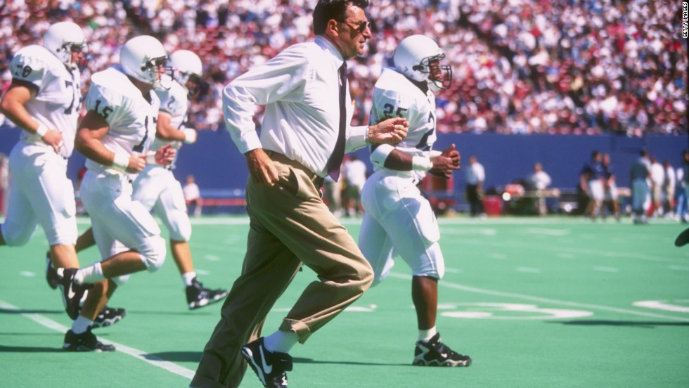 Paterno sprints off the field with his team at halftime in a 1996 game.