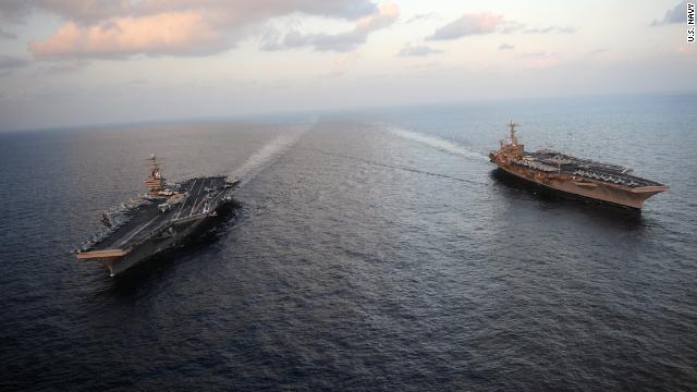 After Iran threat, U.S. aircraft carrier goes through Strait of Hormuz ...