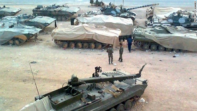 A  picture released by the Local Coordination Committees in Syria shows troops taking position in Homs on January 19, 2012 .