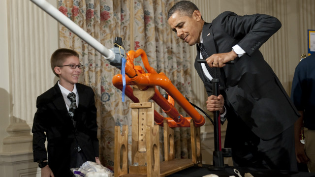 US President Barack Obama, alongside 14-year-old Joey Hudy of Phoenix, Arizona, using a pump to increase the pressure prior to launching a marshmallow from Hudy&#39;s &#39;Extreme Marshmallow Cannon&#39; .