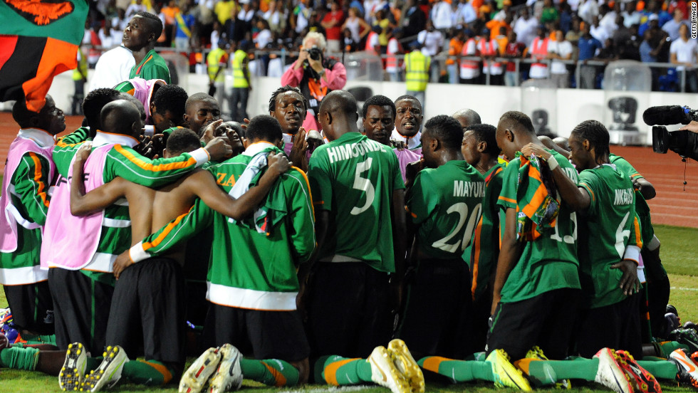 The Zambia team gather together in prayer moments after Stoppila Sunzu&#39;s penalty earned the Copper Bullets&#39; first African title.
