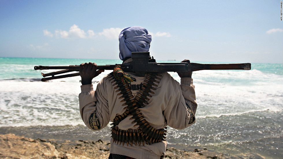 Heavily armed pirates have taken advantage of the nation&#39;s lawless coastal waters to become a major threat to international shipping in the area. In this photo, a gun-wielding pirate keeps vigil along the coastline at Hobyo town, north-eastern Somalia, 2009. 