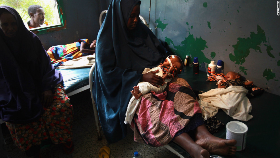 Amid the violence, the Somali people have endured bouts of natural disasters, including famine, drought and floods. In this picture, Farhiyo Hassan sits with her sick and malnourished two month-old twins at the Banadir hospital in Mogadishu, in August 2011. The U.S. government said 30,000 children had died in Somalia due to famine in the previous three months alone.