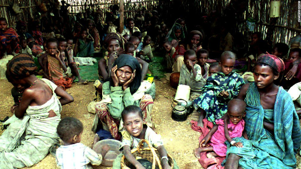 For over 20 years Somalians have faced the horror of famine and war. In this image from 1992, women and children sit inside a feeding centre run by the International Committee for the Red Cross (ICRC) in Baidoha, Somalia, during a period of extreme famine and drought that claimed  300,000 lives, according to the U.N. Security Council. 