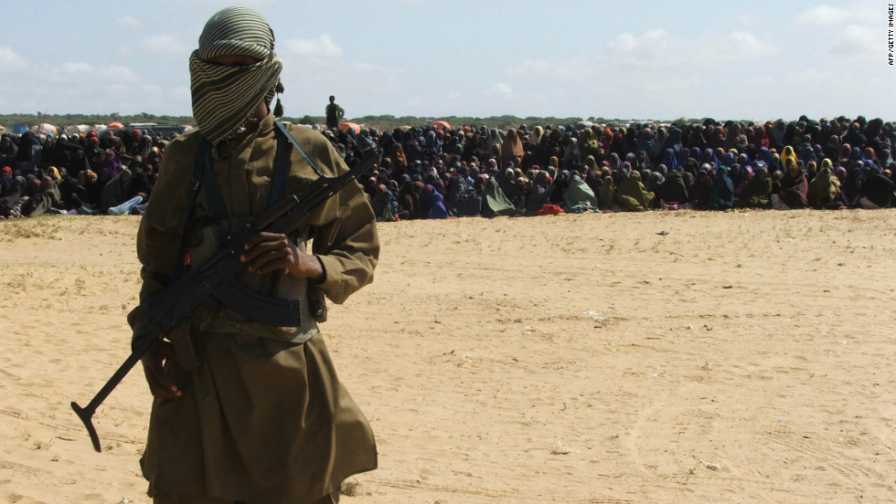 An Islamist fighter stands guard as hundreds of residents watch an amputation punishment carried out. Al-Shabaab&#39;s implementation of strict Sharia law has begun to alienate many in the way that al Qaeda did in Iraq. Women have been stoned to death for adultery; amputations and beheadings are common. In some areas Al-Shabaab has banned listening to the radio and non-Arabic signs; and it has assassinated several journalists.