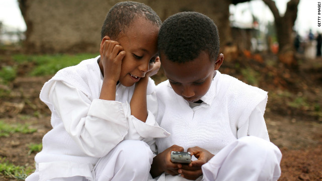 Two boys play with a cellular phone in Debre Zeit, Ethiopia. 