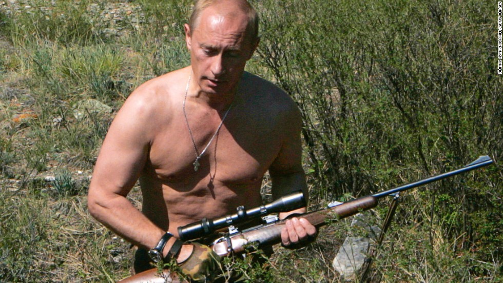 Putin carries a hunting rifle in the Republic of Tuva on September 3, 2007.