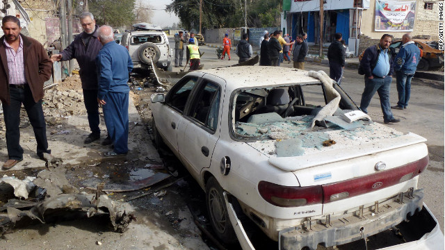 Iraqis inspect the damage after an explosion in central Baghdad on Friday.