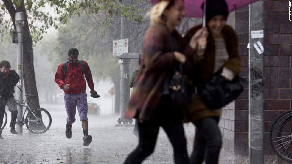 Rain pummels attendees as they dart for cover. 