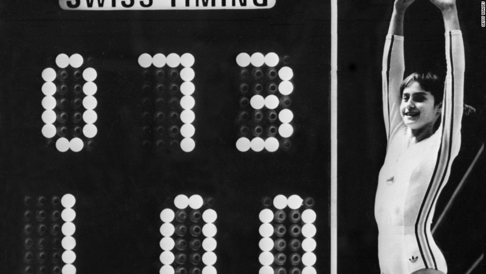 The Perfect 10: Nadia Comaneci celebrates next to the scoreboard after her uneven bars performance at the 1976 Montreal Olympics.