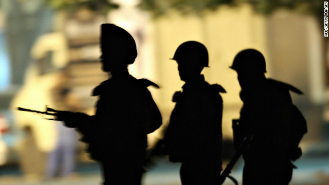 Indian Army soldiers take positions outside the Taj Mahal Hotel in Mumbai on November 28, 2008.