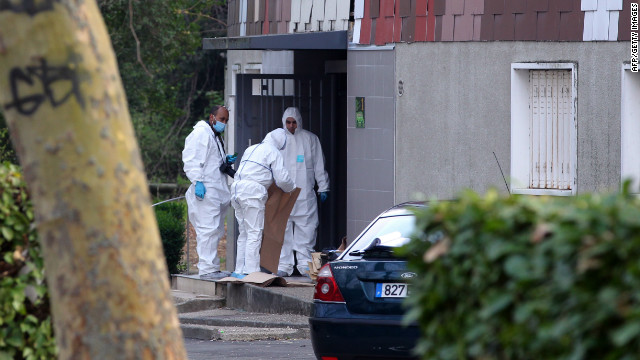 Members of the forensic service of the French police work near where a 47-year-old woman was shot in the head on April 5.