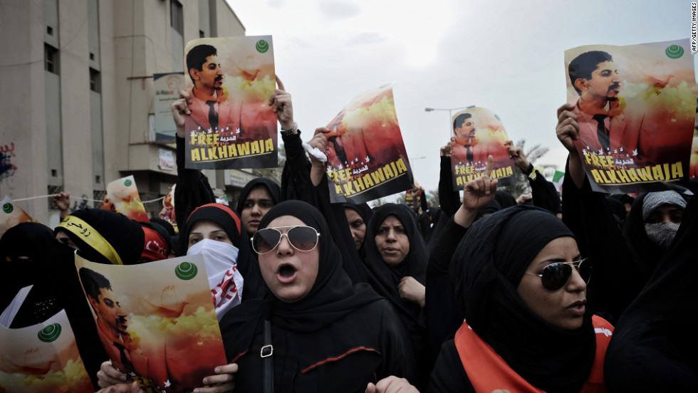 Bahraini Shiite demonstrators hold posters of jailed activist Abdulhadi al-Khawaja during a protest calling for his release in the village of Jidhafs, west of Manama, on April 6, 2012. 