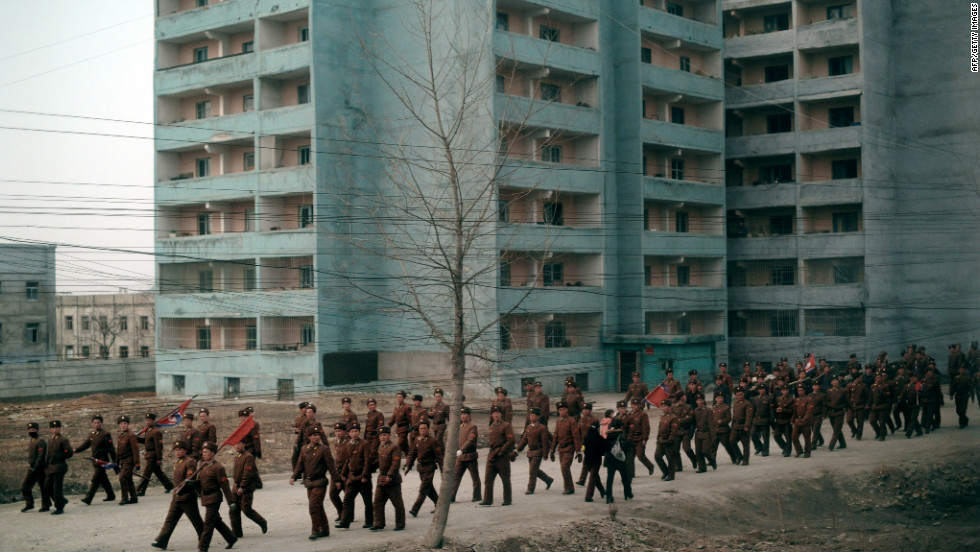 North Korean soldiers are seen from the window of a train along the railway heading from Pyongyang to the North Pyongan Province on the west coast.