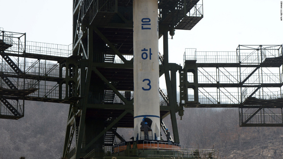 North Korean technicians check the Unha-3 rocket at Tangachai-ri space center on Sunday, April 8.