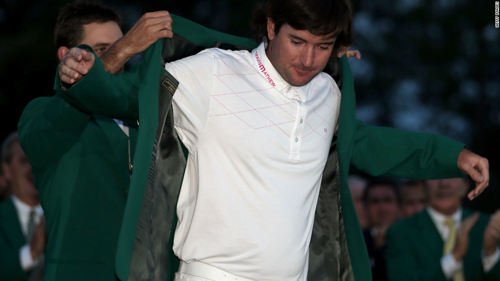 Bubba Watson receives the green jacket from 2011 winner Charl Schwartzel of South Africa.